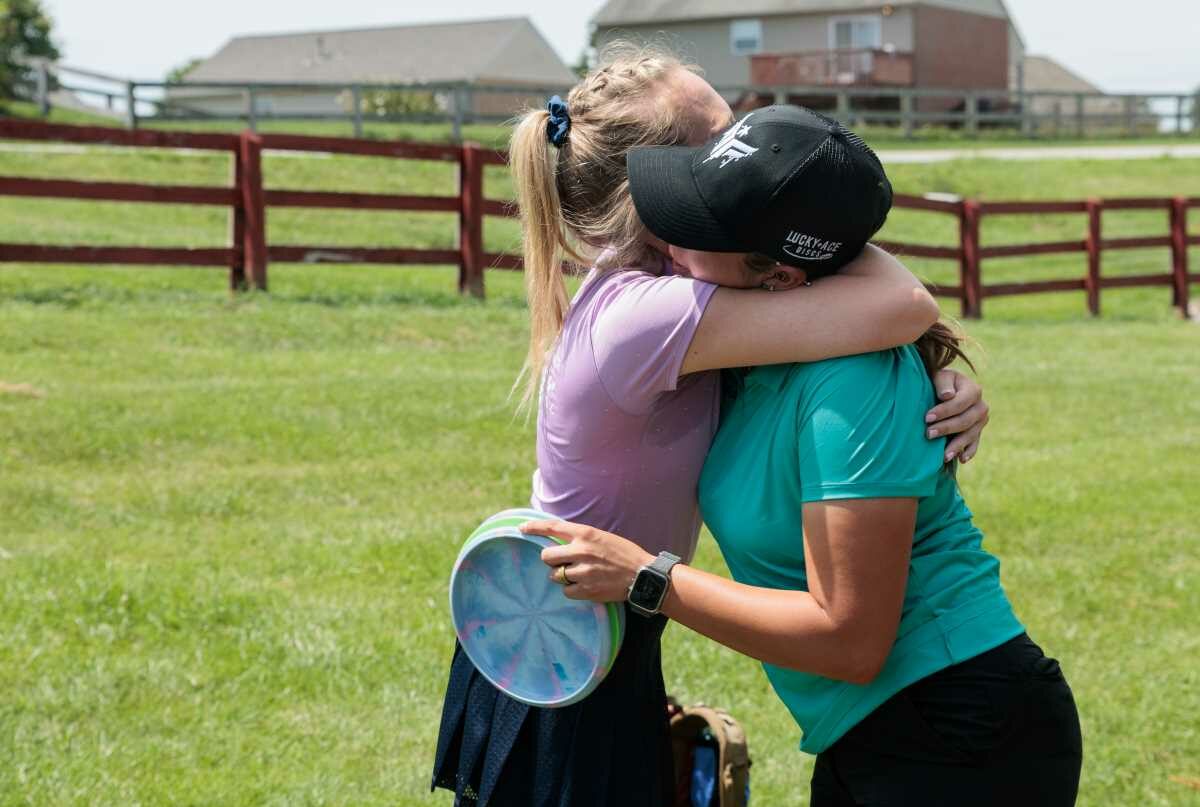 Disc Golfers Hugging after a completed round.